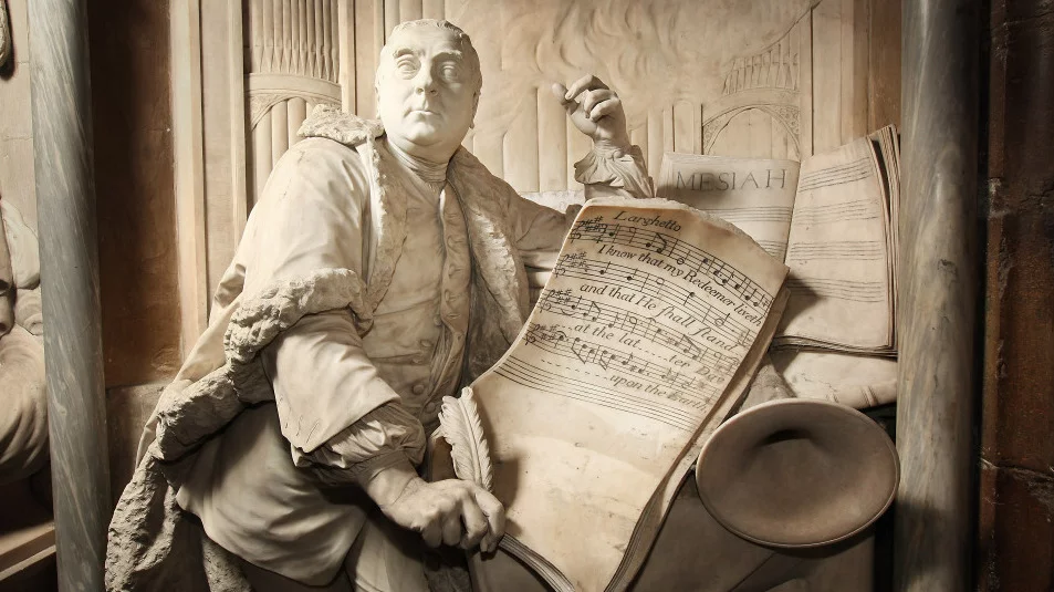 A statue of George Frideric Handel, posing with his Messiah transcript, at London&#39;s Westminster Abbey..jpg